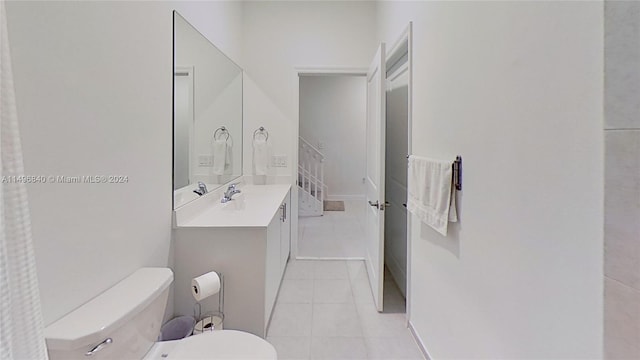 bathroom with vanity, tile floors, and toilet