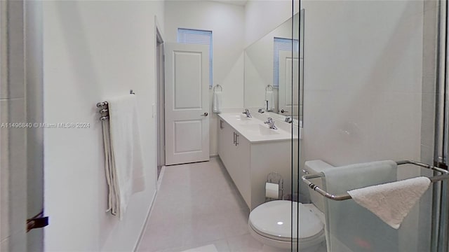 bathroom with vanity, toilet, and tile flooring