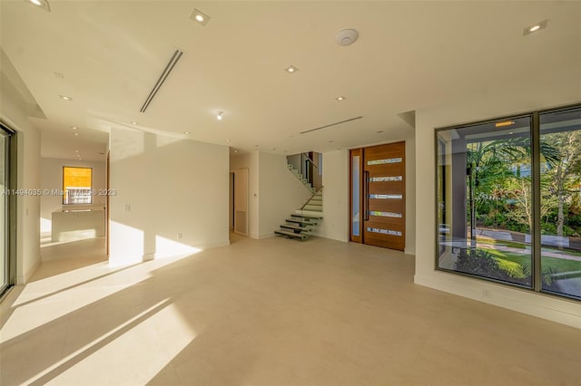 empty room featuring stairs and recessed lighting