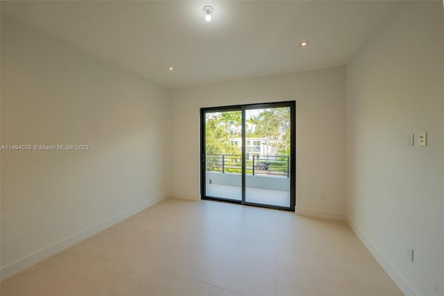 spare room with recessed lighting and baseboards