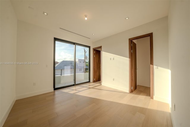 unfurnished room featuring light wood-type flooring and baseboards