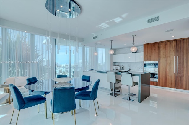 dining space featuring light tile patterned floors and wood walls