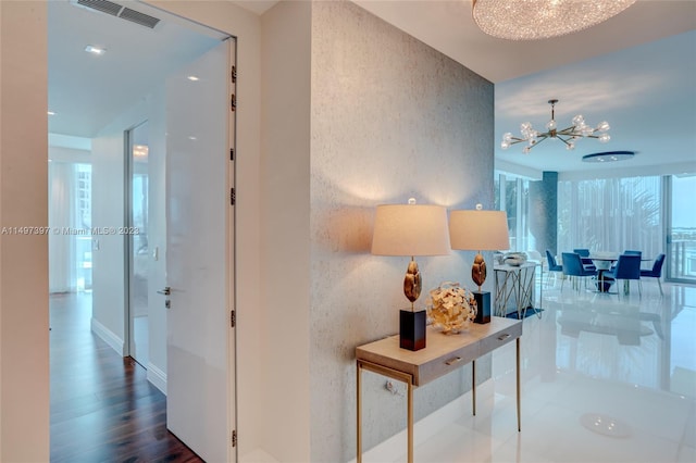 hall with floor to ceiling windows, dark wood-type flooring, and a notable chandelier