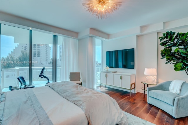 bedroom featuring multiple windows, dark wood-type flooring, and access to exterior