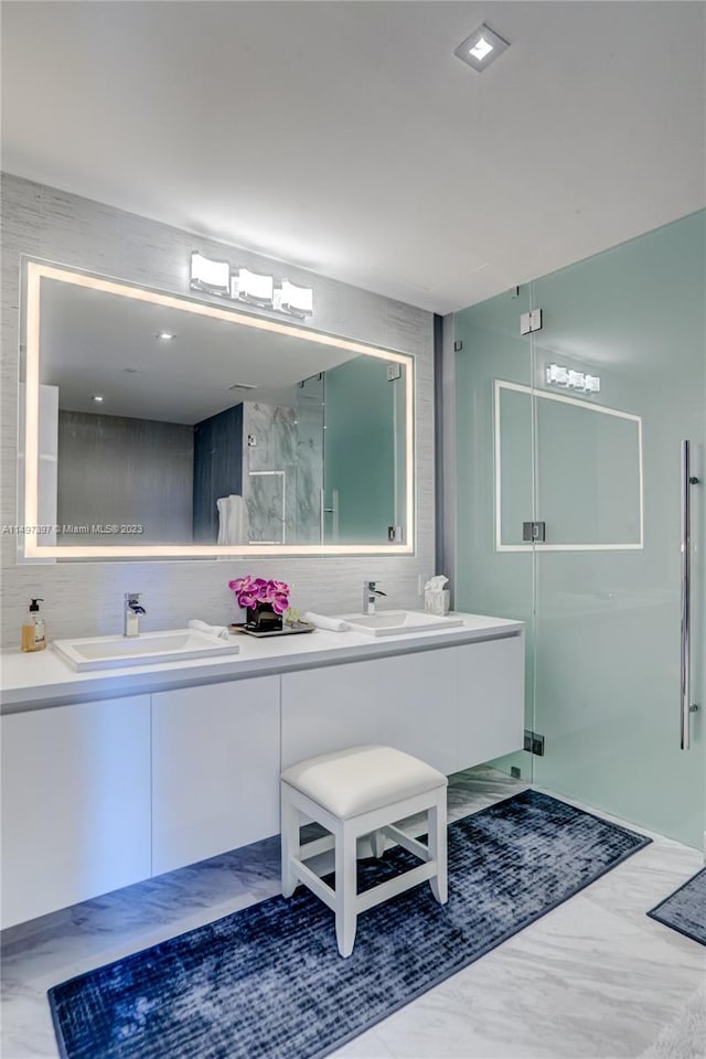 bathroom featuring vanity and a shower with shower door