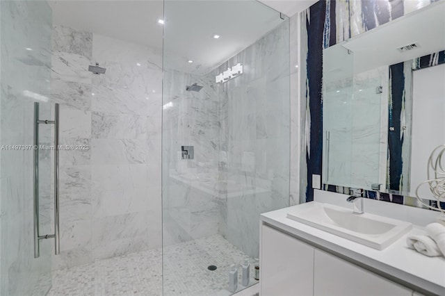 bathroom featuring vanity and an enclosed shower