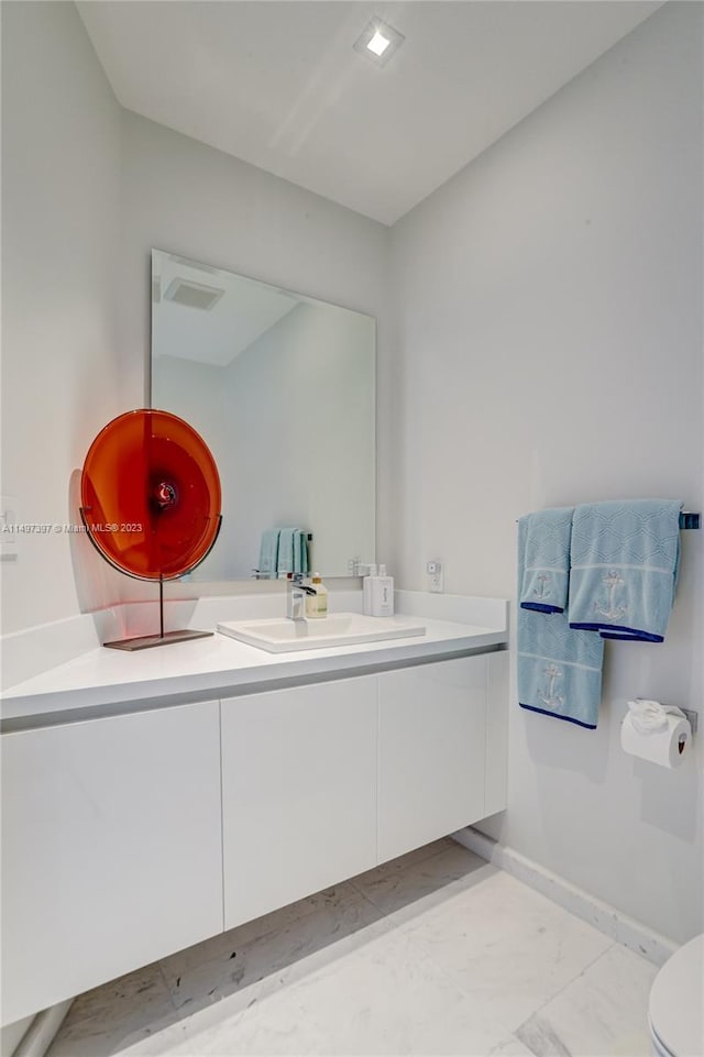 bathroom featuring vanity and toilet