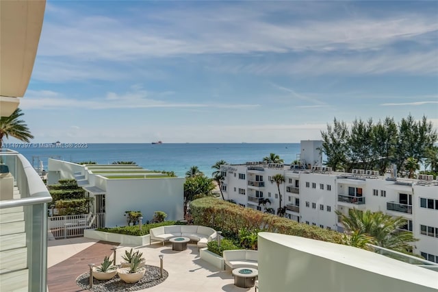 balcony featuring a patio, a water view, and an outdoor hangout area