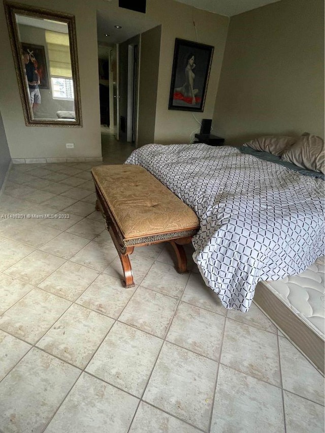 bedroom with light tile floors