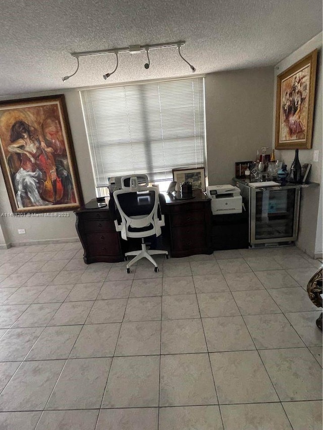 office space featuring light tile floors and a textured ceiling