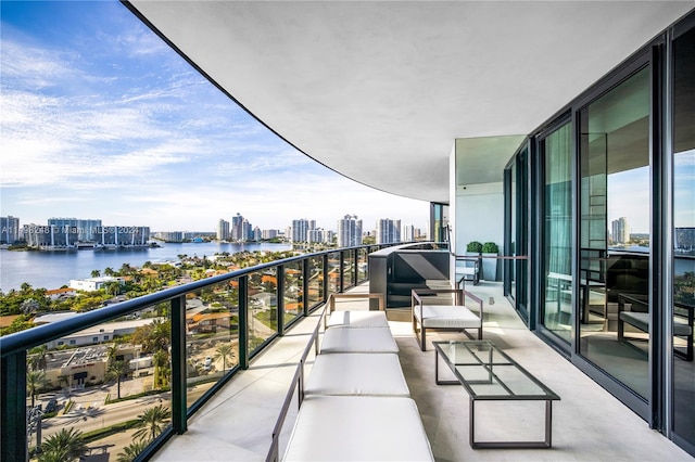 balcony with a water view and an outdoor living space