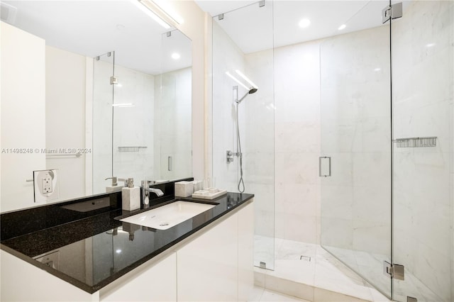 bathroom with tile patterned flooring, vanity, and a shower with door