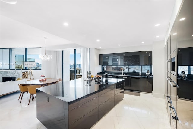 kitchen featuring a large island, a chandelier, hanging light fixtures, and light tile patterned floors