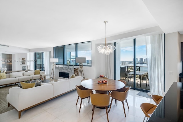 tiled dining space featuring a chandelier, a premium fireplace, and expansive windows