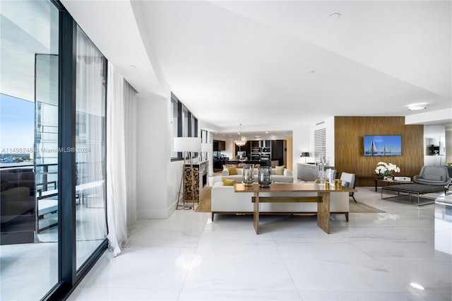 living room featuring wooden walls and expansive windows