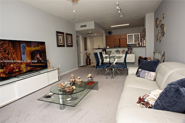 carpeted living room with baseboards and visible vents