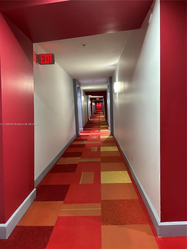 hall featuring baseboards and tile patterned floors