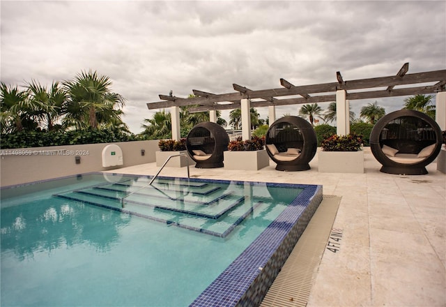 community pool with a patio and a pergola