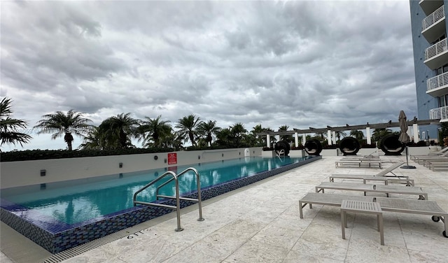 view of pool with a pergola and a patio area