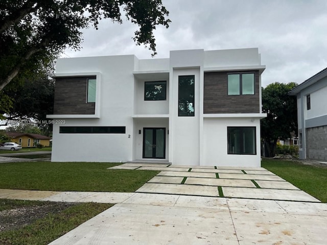 modern home featuring a garage and a front yard