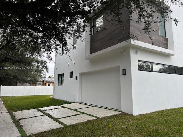 view of side of property with a garage and a yard