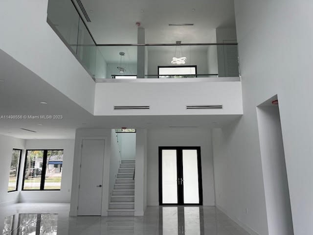 interior space with a high ceiling and french doors