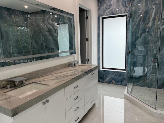 bathroom featuring vanity and a shower with shower door