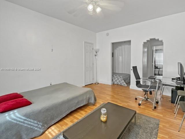 bedroom featuring hardwood / wood-style floors and ceiling fan