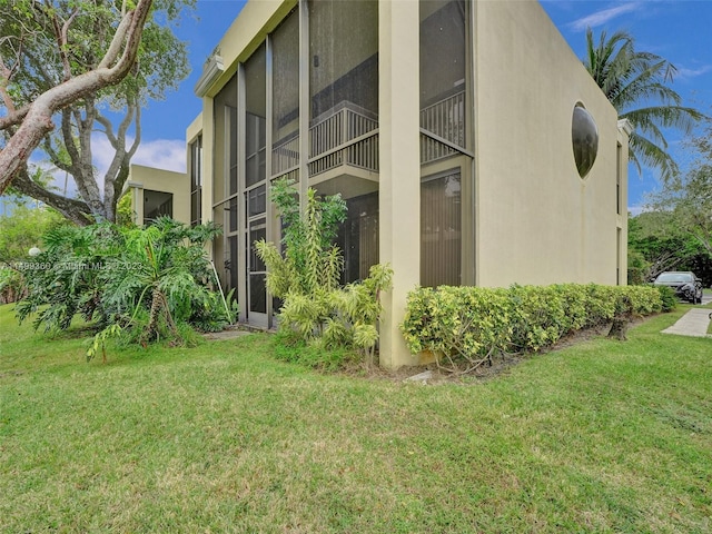 view of property exterior with a lawn