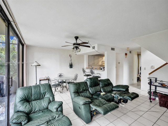 tiled living room featuring ceiling fan