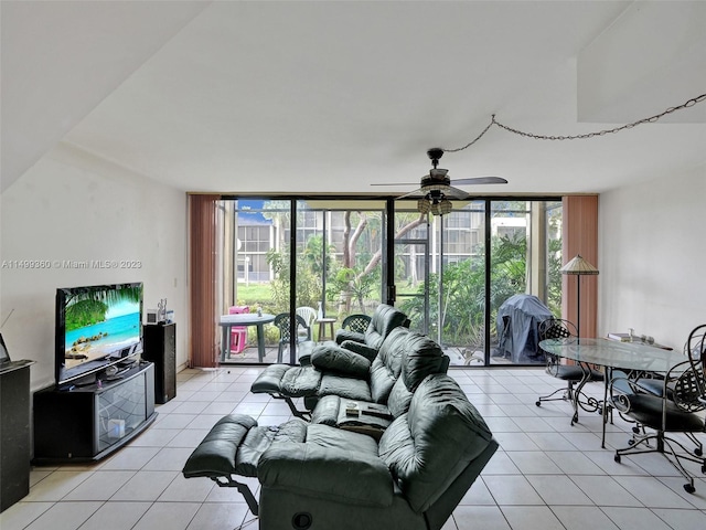 tiled living room featuring ceiling fan, plenty of natural light, and floor to ceiling windows