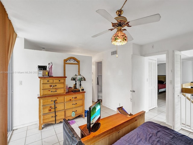 bedroom with ceiling fan and light tile patterned flooring