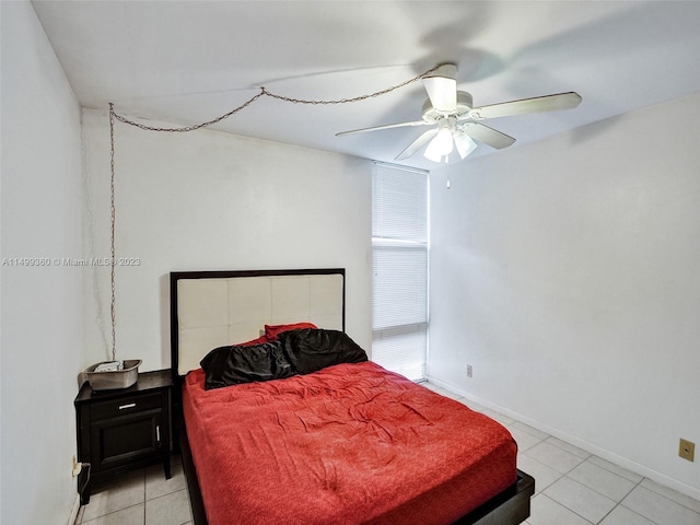 tiled bedroom featuring ceiling fan