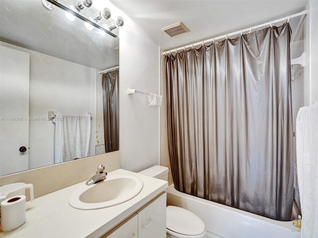 full bathroom featuring shower / bath combo with shower curtain, toilet, and vanity