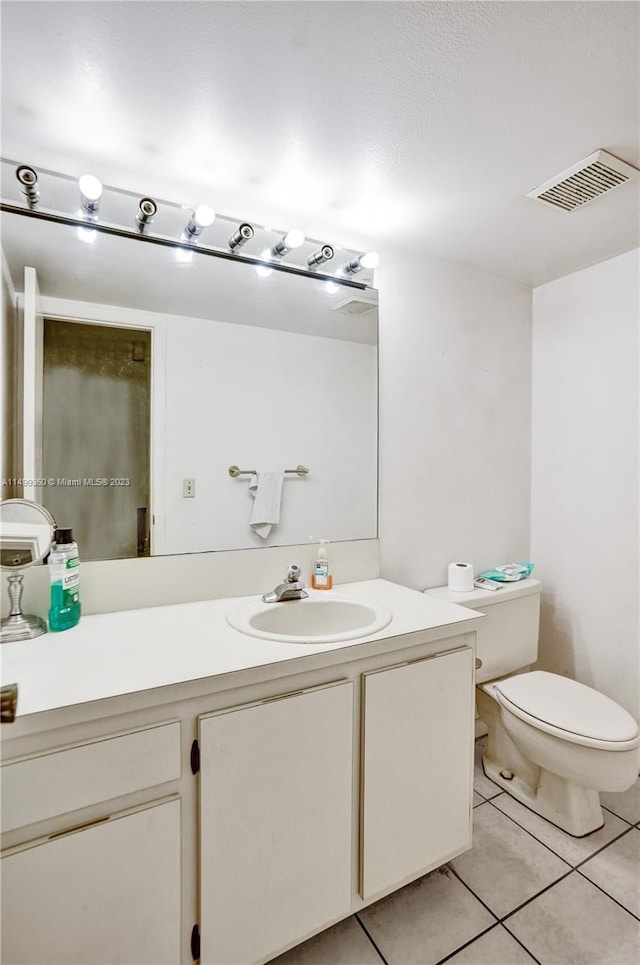 bathroom featuring tile patterned floors, toilet, and vanity