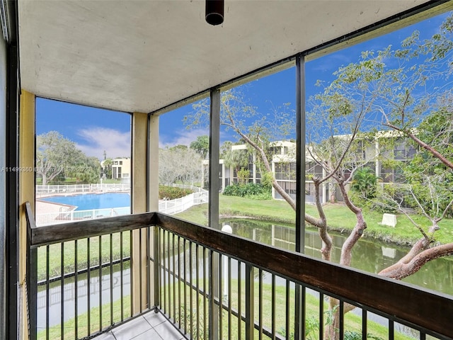 unfurnished sunroom with a water view