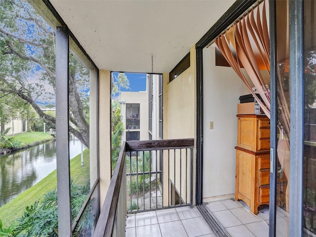 unfurnished sunroom with a water view