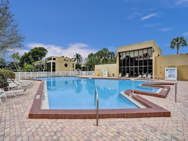 view of pool featuring a hot tub and a patio