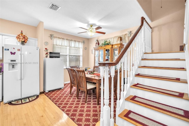 dining area with light hardwood / wood-style floors and ceiling fan