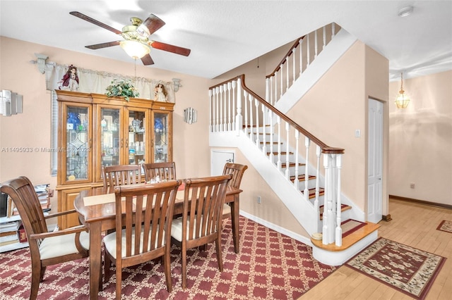 dining space with light hardwood / wood-style floors and ceiling fan