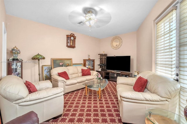 living room featuring carpet floors and ceiling fan