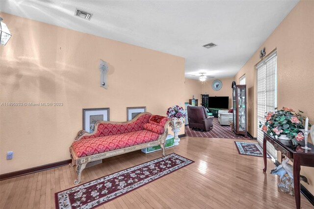 living room featuring ceiling fan and light hardwood / wood-style flooring