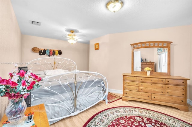 bedroom with light hardwood / wood-style floors and ceiling fan