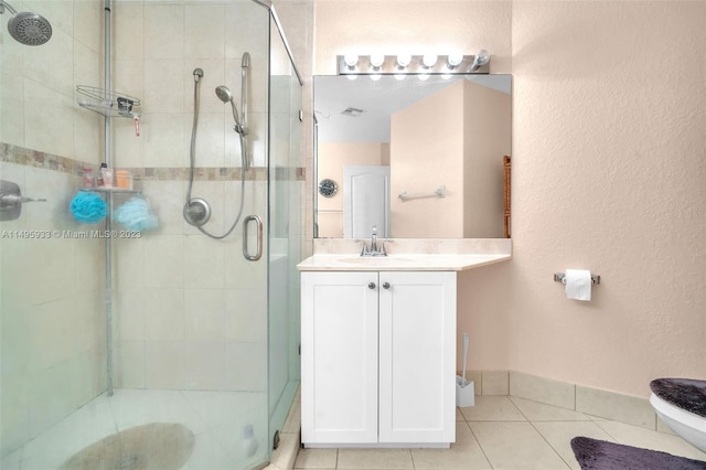 bathroom featuring large vanity, tile flooring, and walk in shower