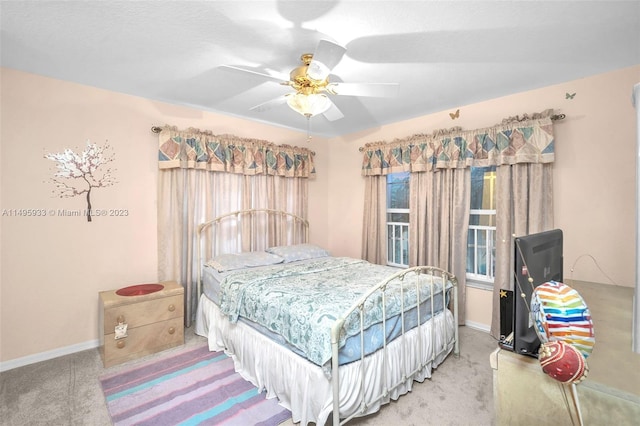 bedroom with light carpet and ceiling fan