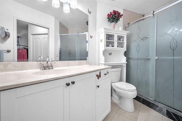 bathroom featuring an enclosed shower, toilet, vanity, and tile flooring