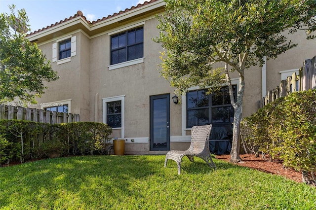 rear view of property with a lawn