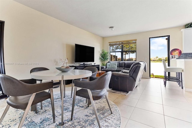 dining space featuring light tile patterned floors