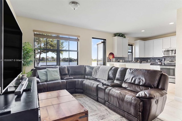 living room with plenty of natural light and light tile patterned floors