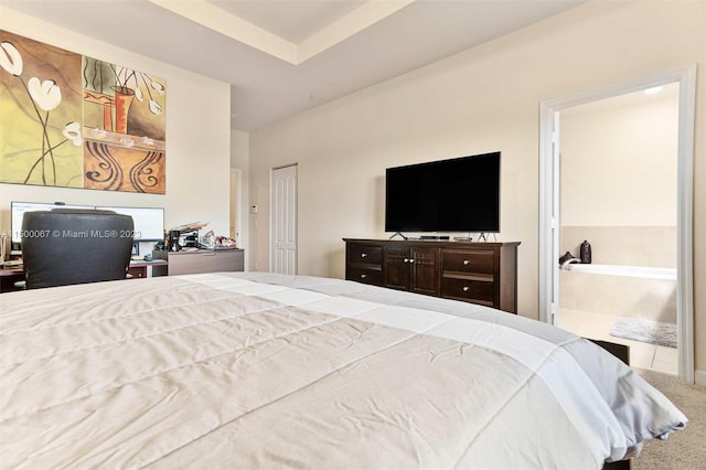 carpeted bedroom featuring connected bathroom and a closet